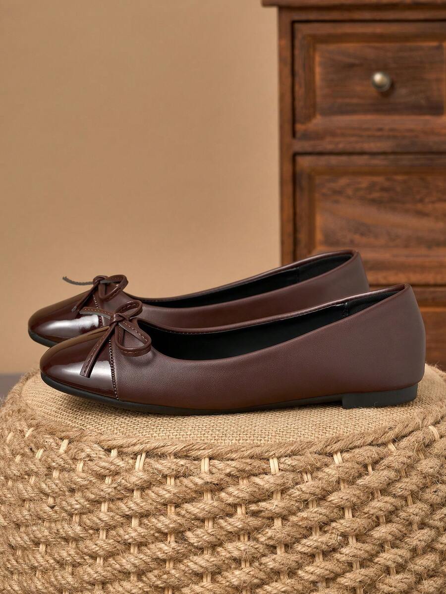 Pair of women's square toe slip-on flat shoes featuring a delicate bow detail and low vamp design.