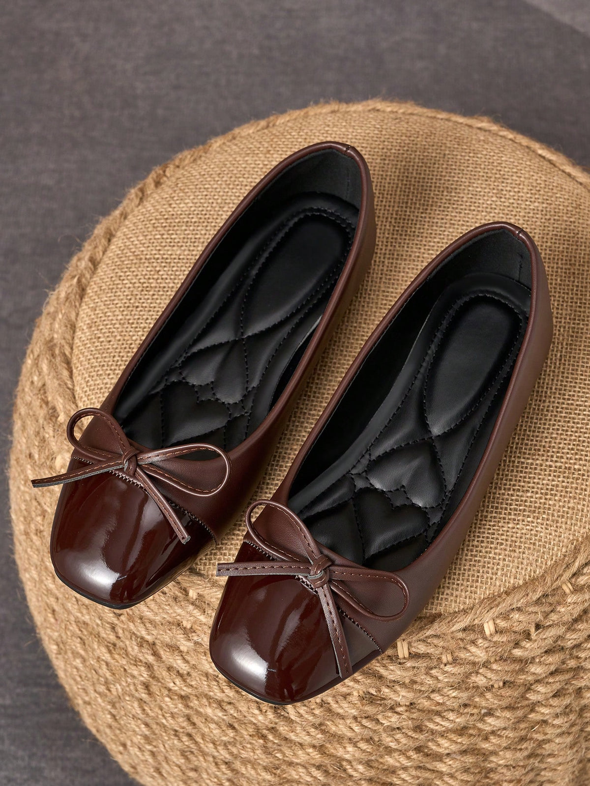 Pair of women's square toe slip-on flat shoes featuring a delicate bow detail and low vamp design.