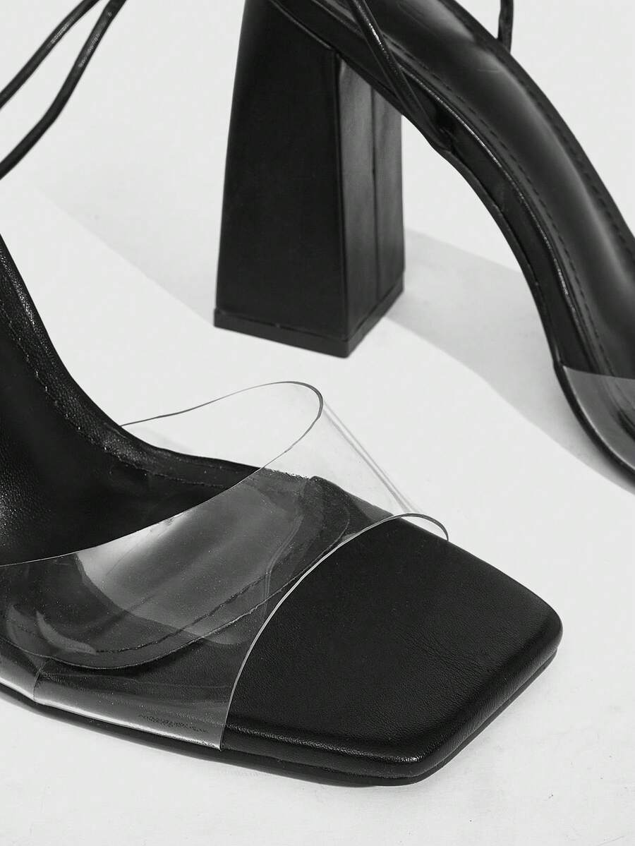 Women's criss-cross lace-up chunky high heel sandals with open square toe and strappy design.