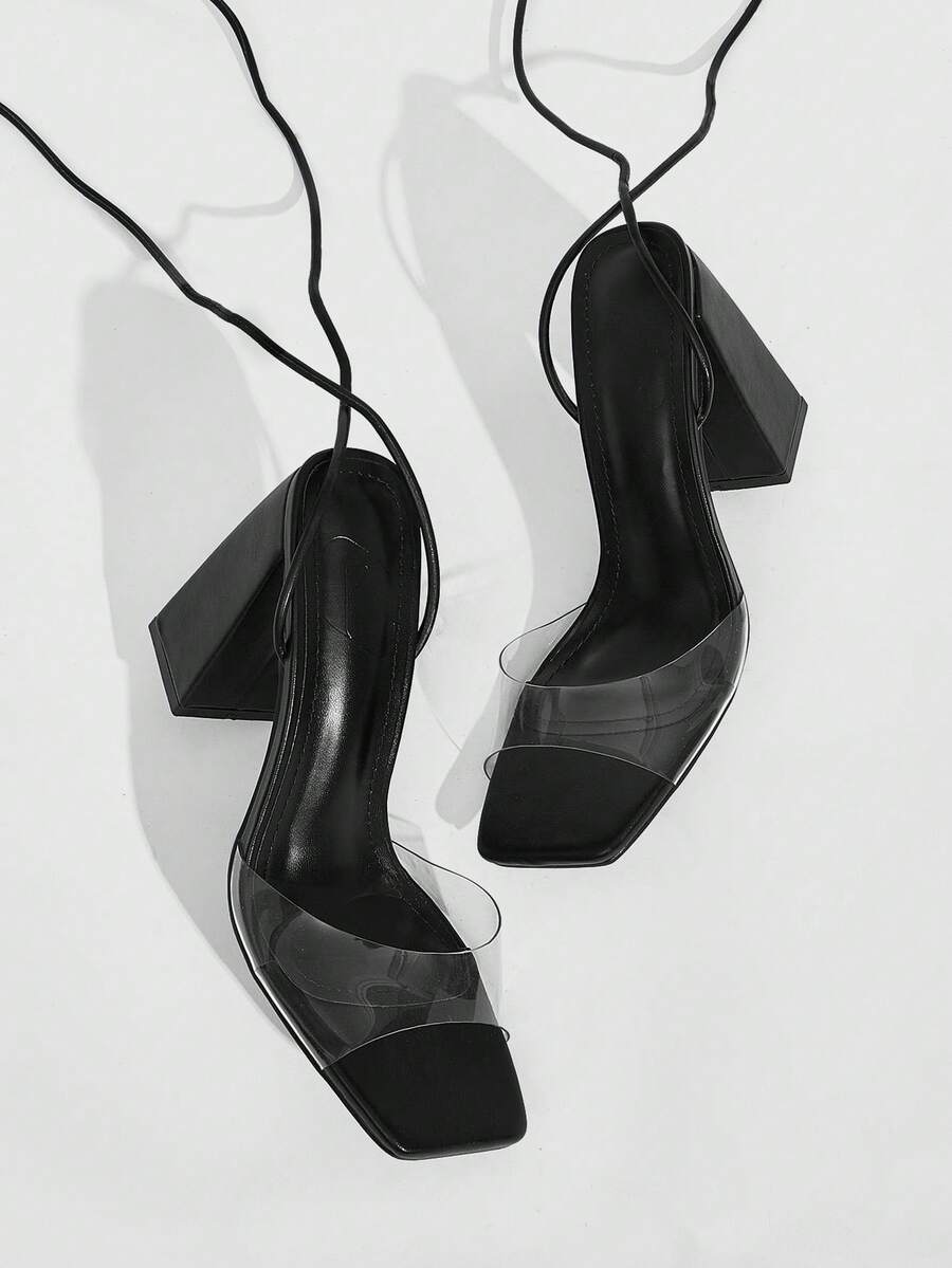 Women's criss-cross lace-up chunky high heel sandals with open square toe and strappy design.