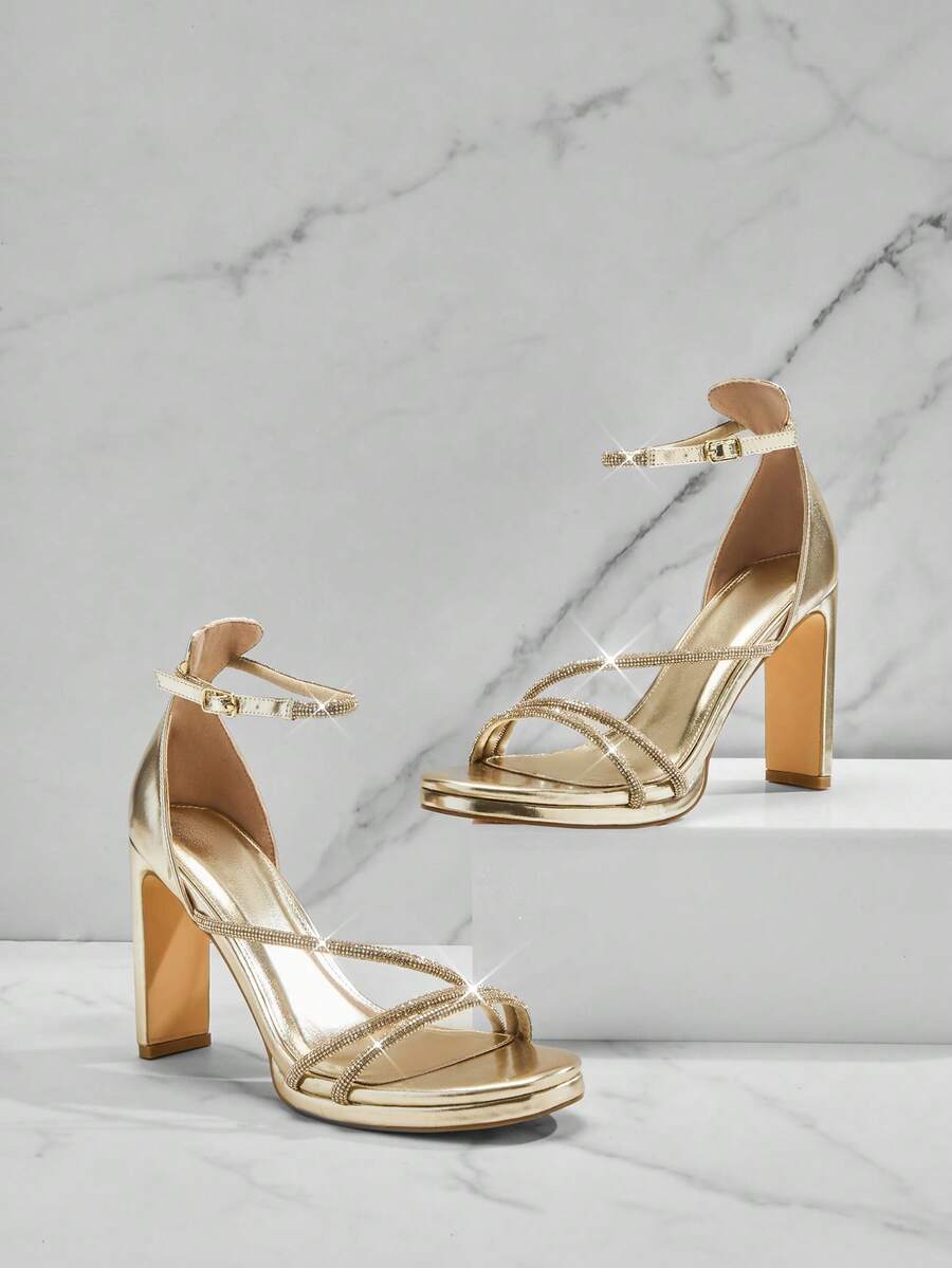 Open square toe high heel sandals with sparkling rhinestone straps, an adjustable ankle buckle closure, and a sleek stiletto heel.