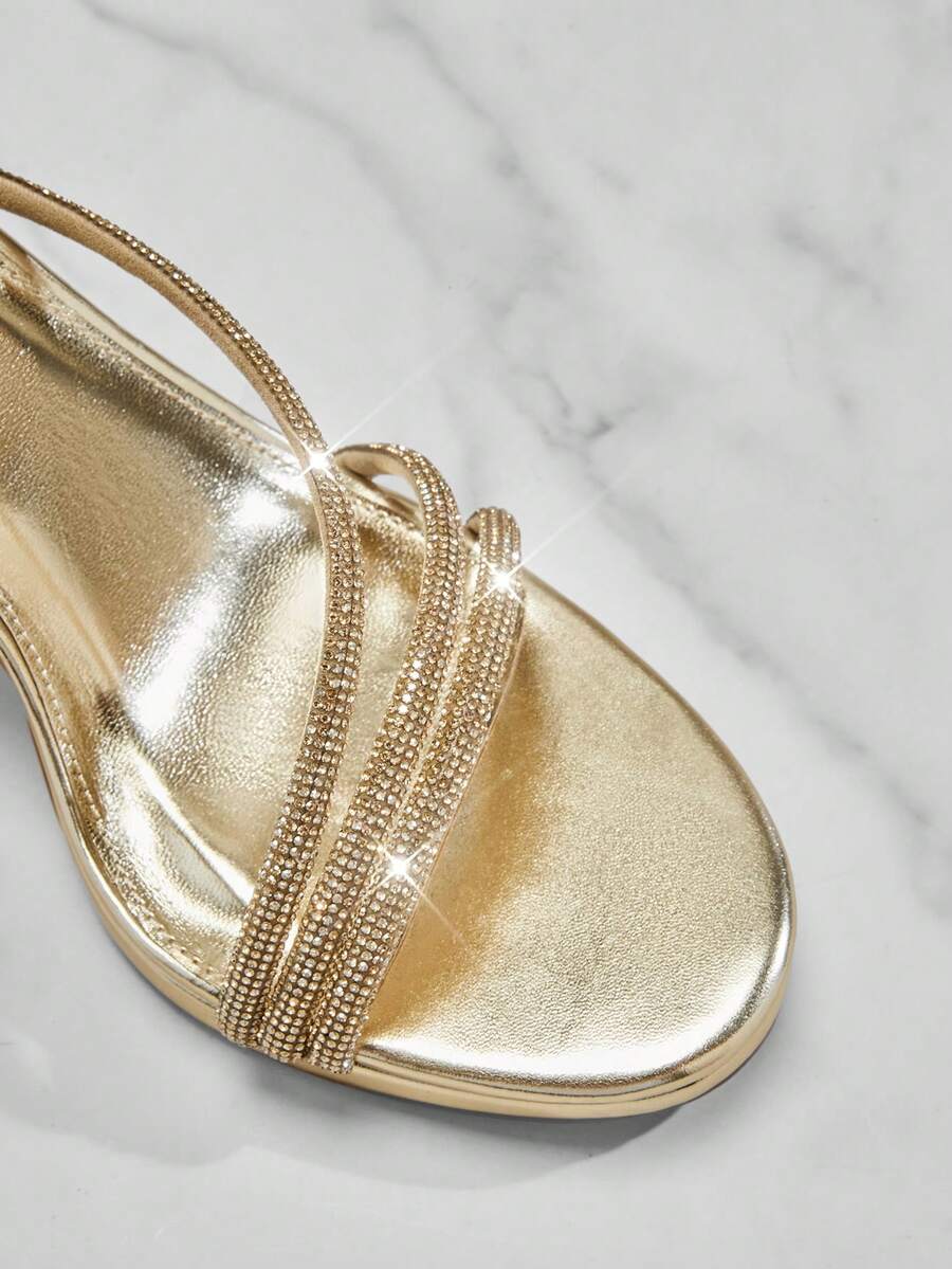 Open square toe high heel sandals with sparkling rhinestone straps, an adjustable ankle buckle closure, and a sleek stiletto heel.