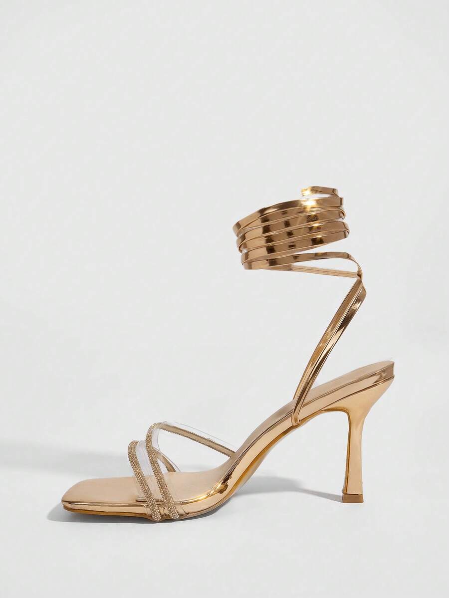 Red shiny patent leather stiletto high heel sandals featuring a square toe and criss-cross ankle strap with buckle closure.