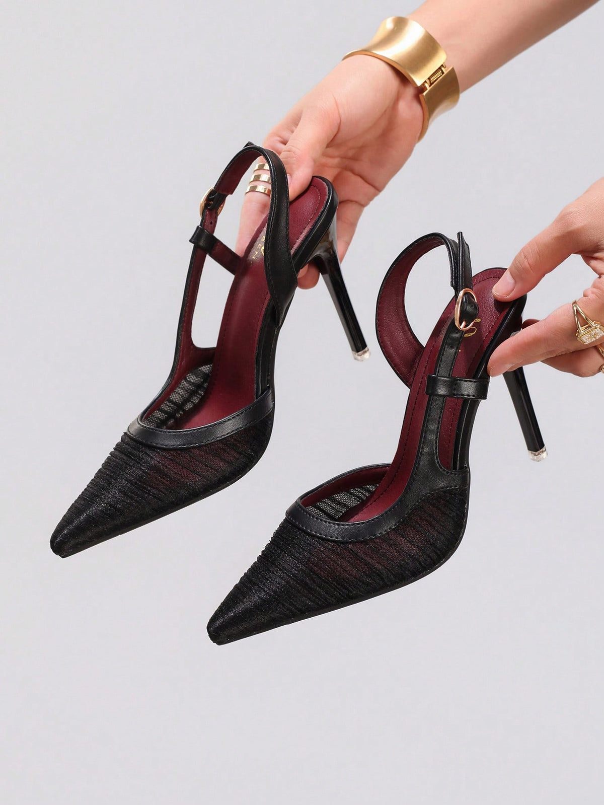 Black lace pointed toe high heel pumps featuring stiletto heels and a decorative bow accent.