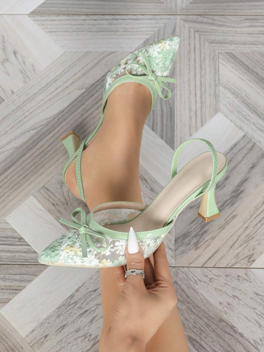 Pointed toe stiletto high heels featuring white mesh lace upper, bowknot accent, and slingback buckle strap.