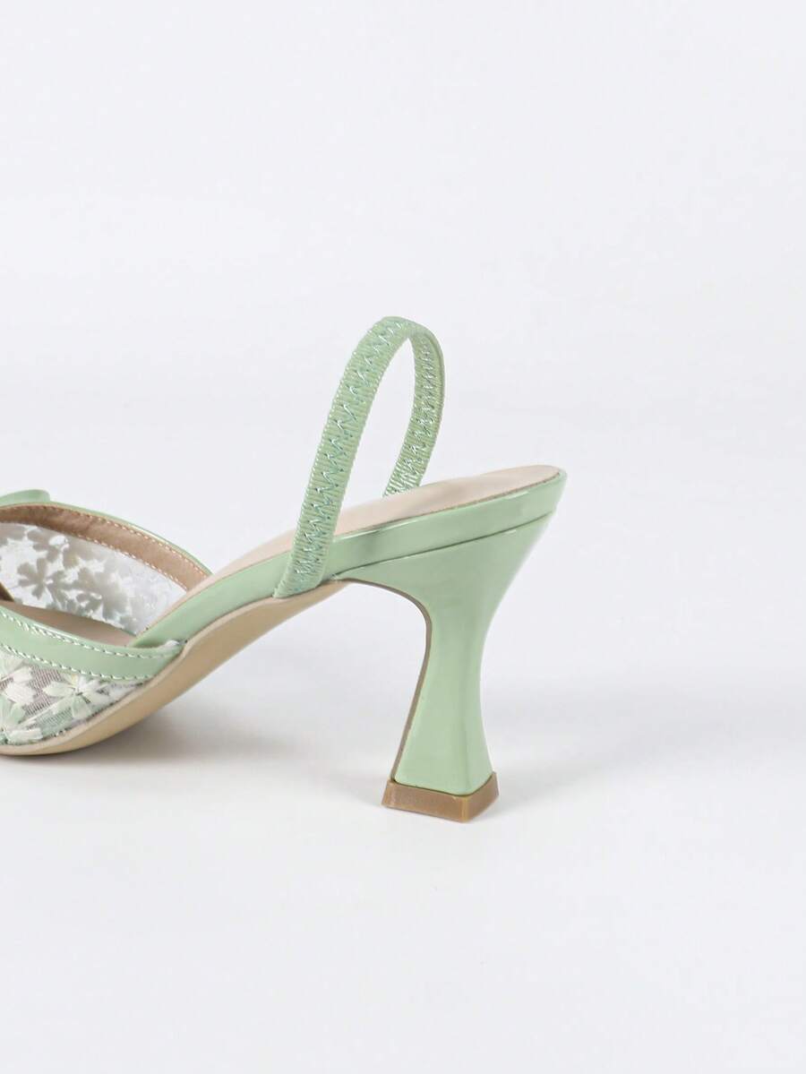 Pointed toe stiletto high heels featuring white mesh lace upper, bowknot accent, and slingback buckle strap.