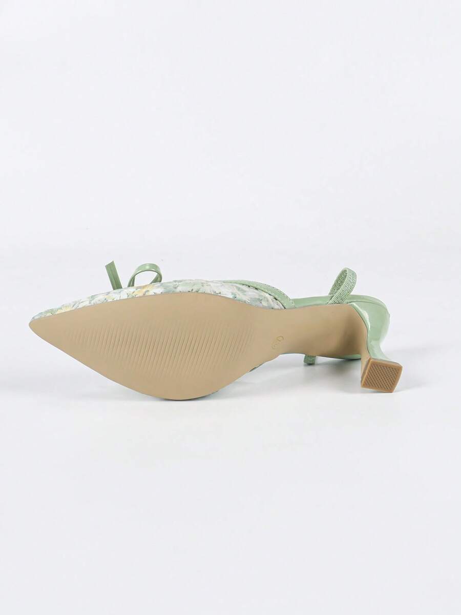 Pointed toe stiletto high heels featuring white mesh lace upper, bowknot accent, and slingback buckle strap.