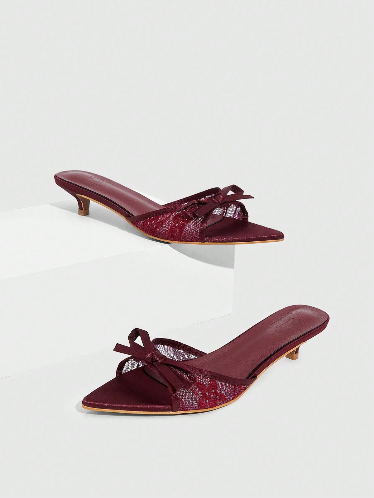 Pointed toe high-heeled slippers in PU leather with decorative buckle detail and low kitten heels for women.