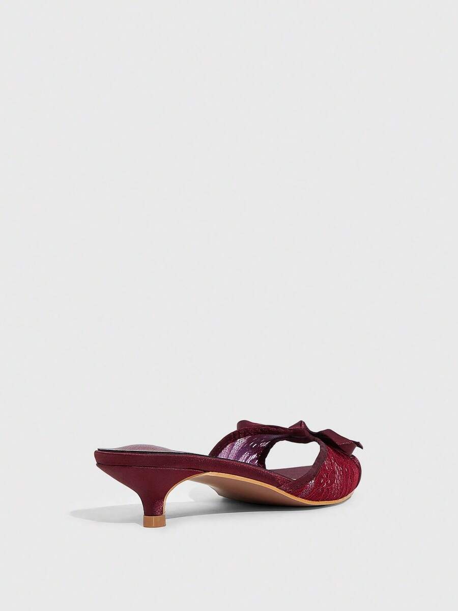 Pointed toe high-heeled slippers in PU leather with decorative buckle detail and low kitten heels for women.