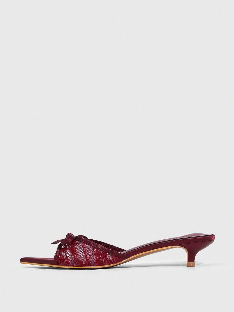 Pointed toe high-heeled slippers in PU leather with decorative buckle detail and low kitten heels for women.