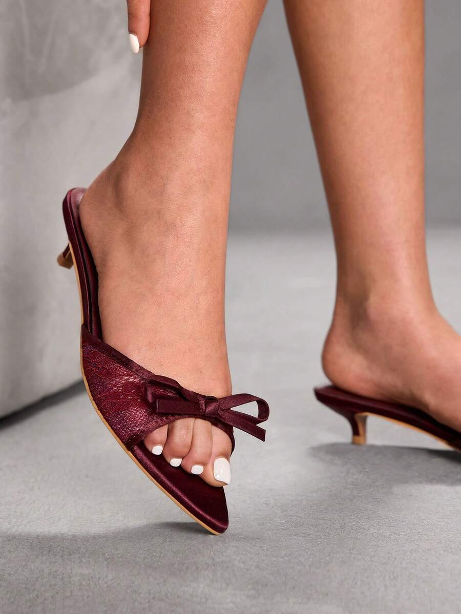 Pointed toe high-heeled slippers in PU leather with decorative buckle detail and low kitten heels for women.