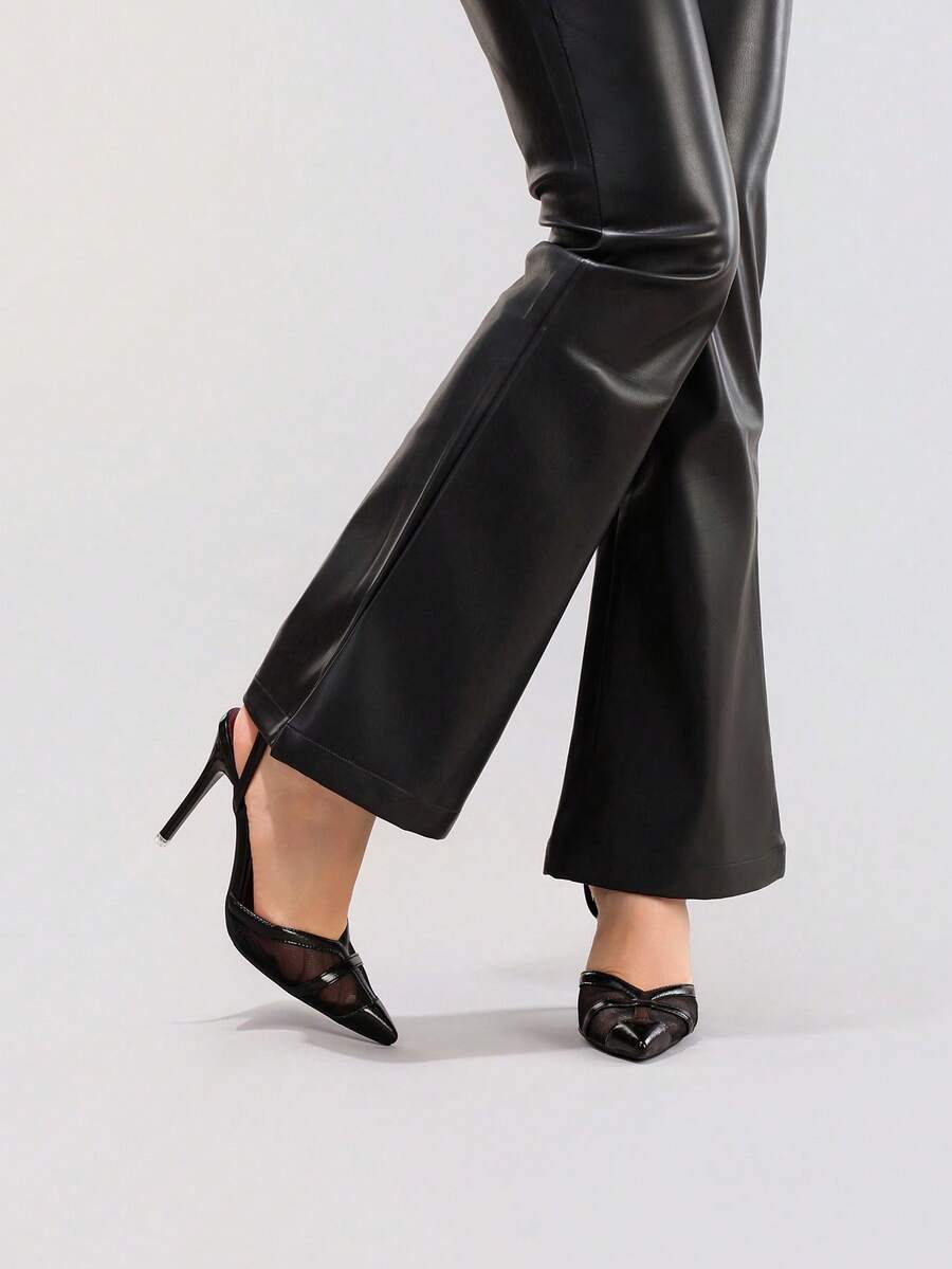 Lace embroidered high heels with thin stiletto heel, pointed toe, rhinestone embellishments, and ankle strap buckle closure.