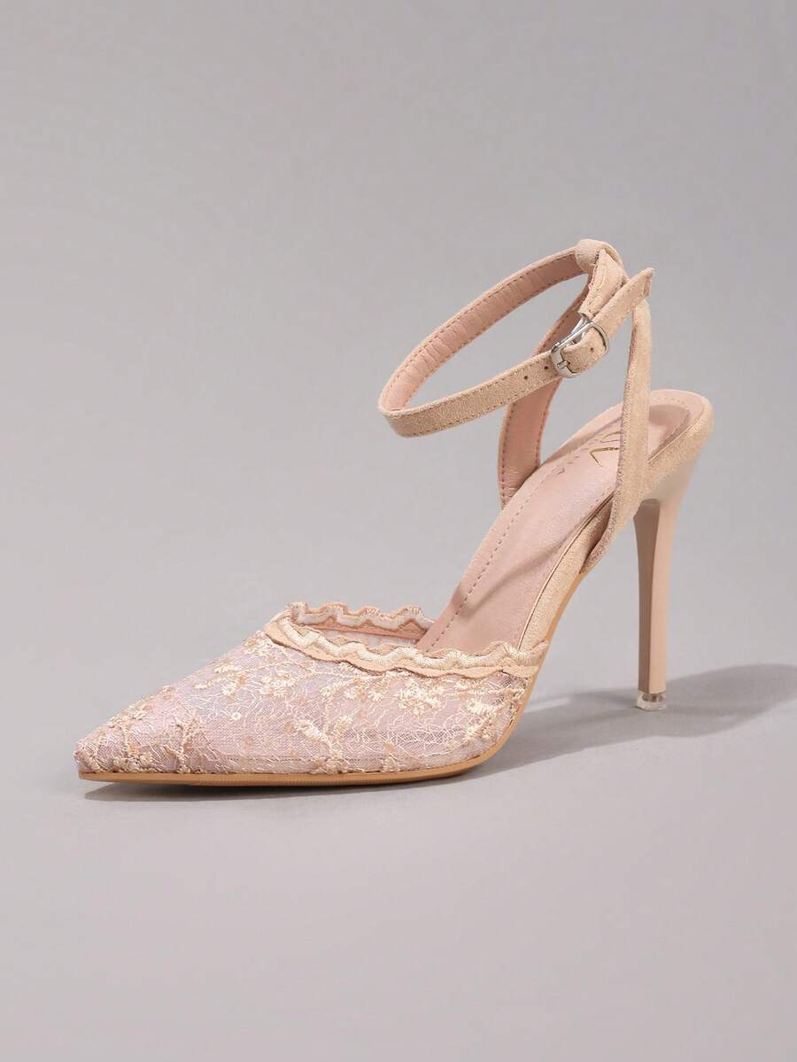 Lace embroidered high heels with thin stiletto heel, pointed toe, rhinestone embellishments, and ankle strap buckle closure.