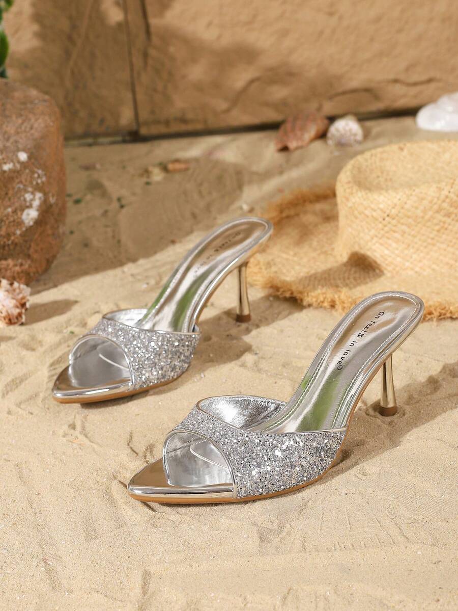 Women's open toe slide sandals featuring sleek patent leather and thin stiletto heels