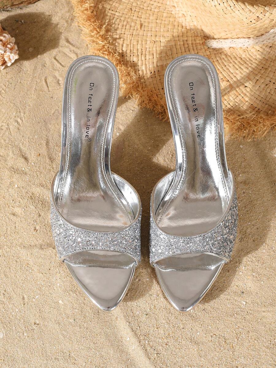 Women's open toe slide sandals featuring sleek patent leather and thin stiletto heels