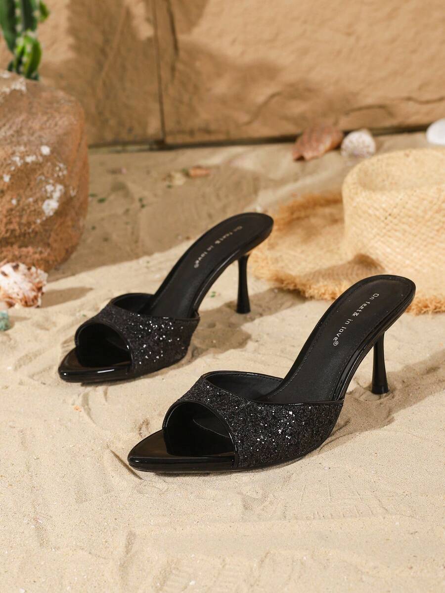 Women's open toe slide sandals featuring sleek patent leather and thin stiletto heels