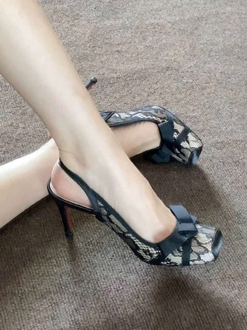 Black lace high heel sandals for women with a big bowknot, closed square toe, and stiletto heel.