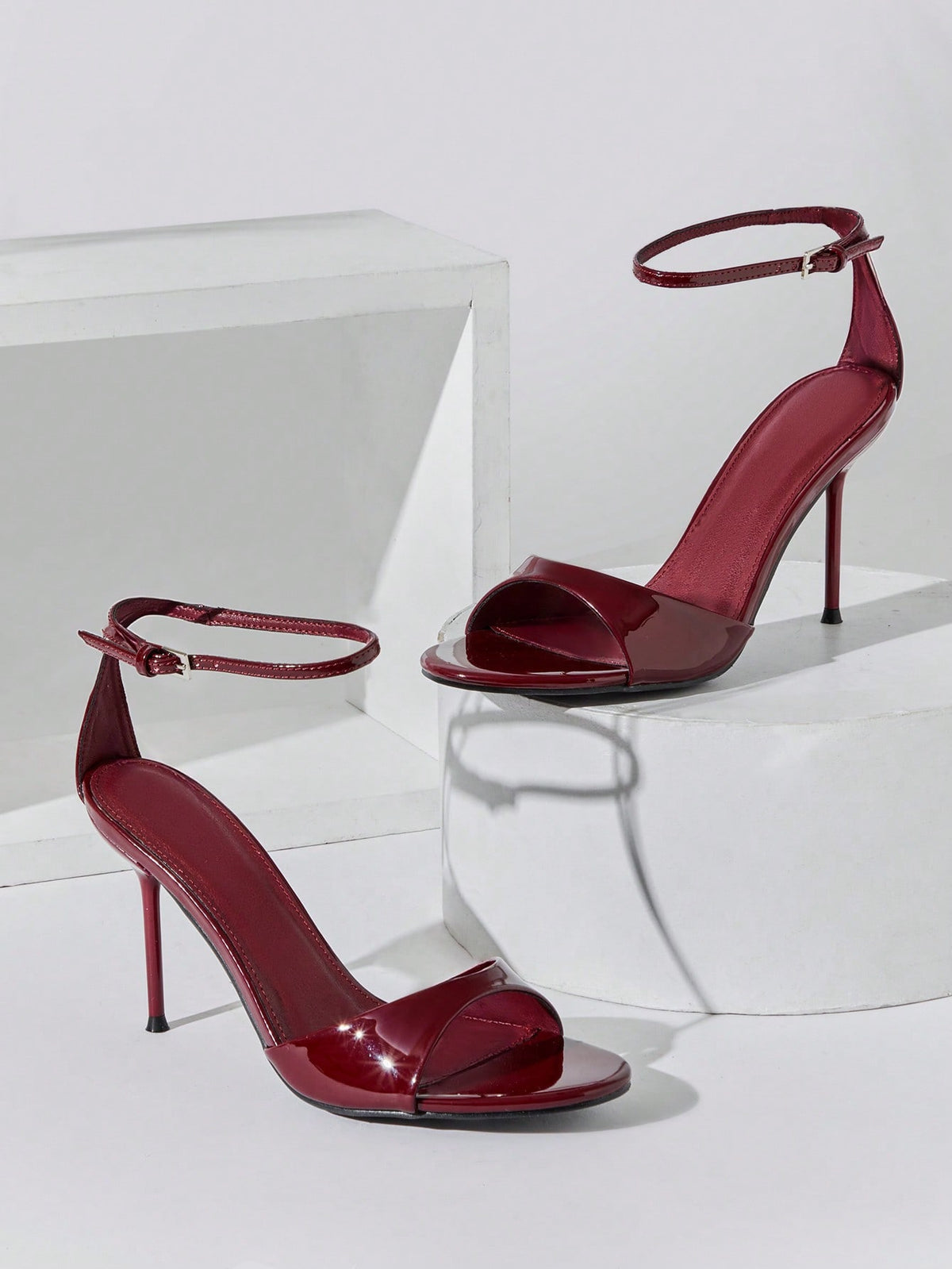 Women's pointed toe stiletto high heel wedding shoes featuring an elegant silhouette and glossy finish.
