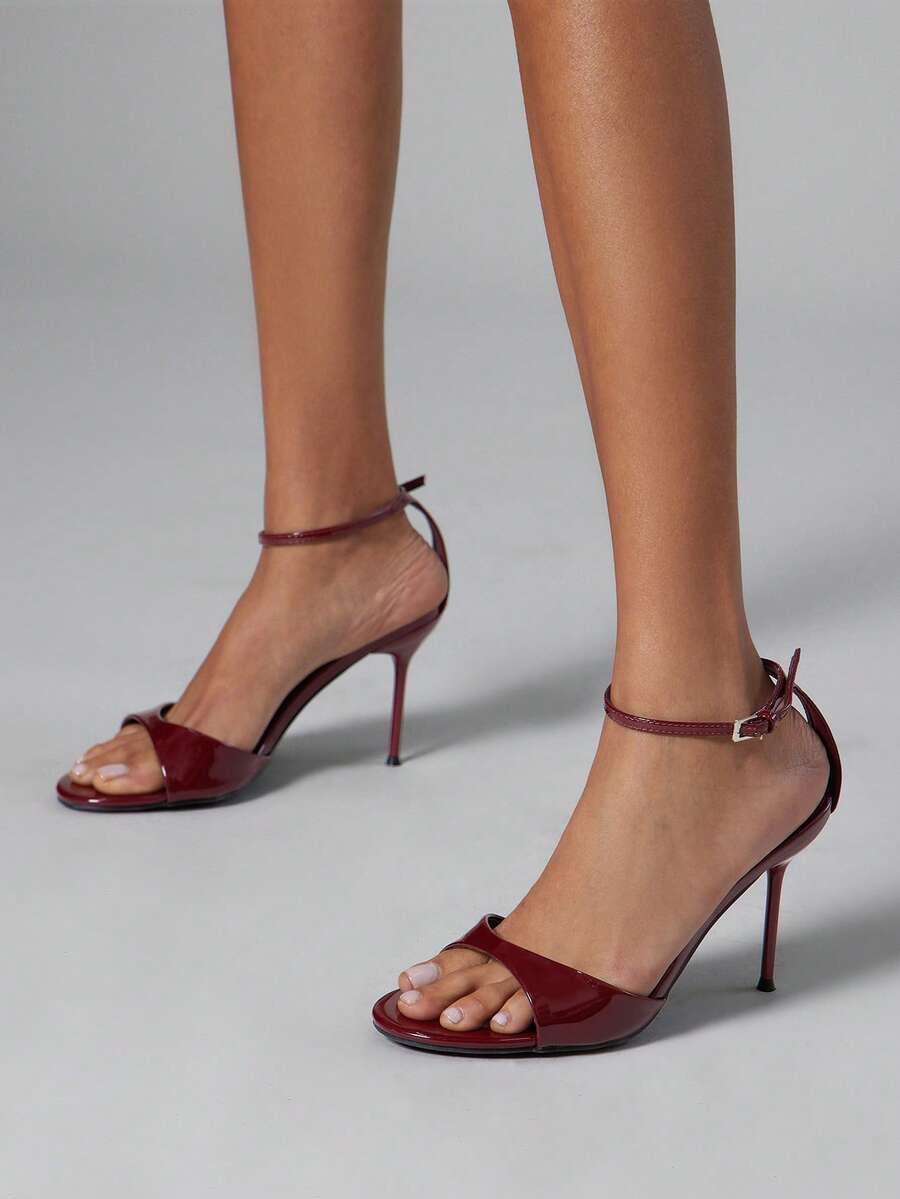 Women's pointed toe stiletto high heel wedding shoes featuring an elegant silhouette and glossy finish.