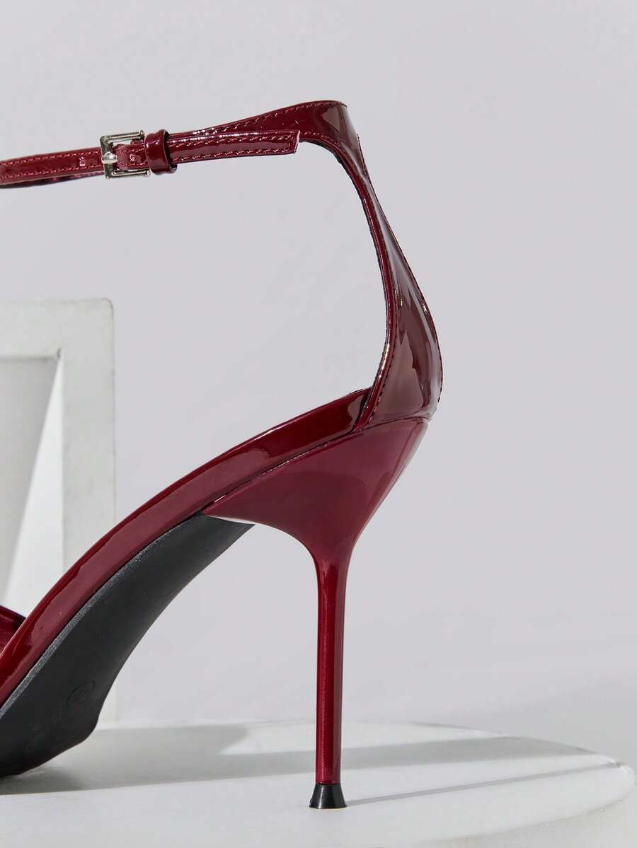 Women's pointed toe stiletto high heel wedding shoes featuring an elegant silhouette and glossy finish.