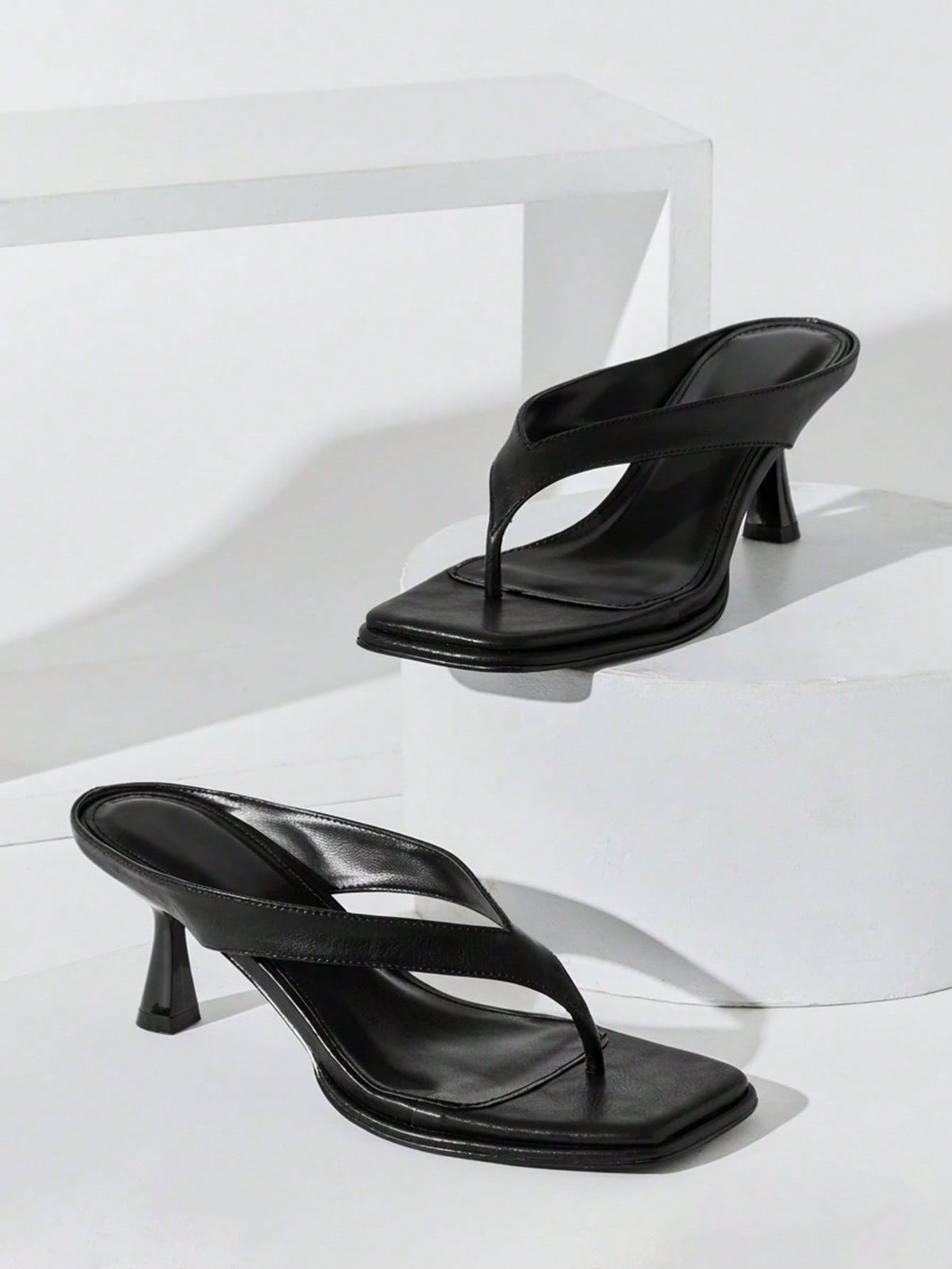 Women's minimalist black PU leather thong heel sandals featuring kitten heels and rhinestone accents
