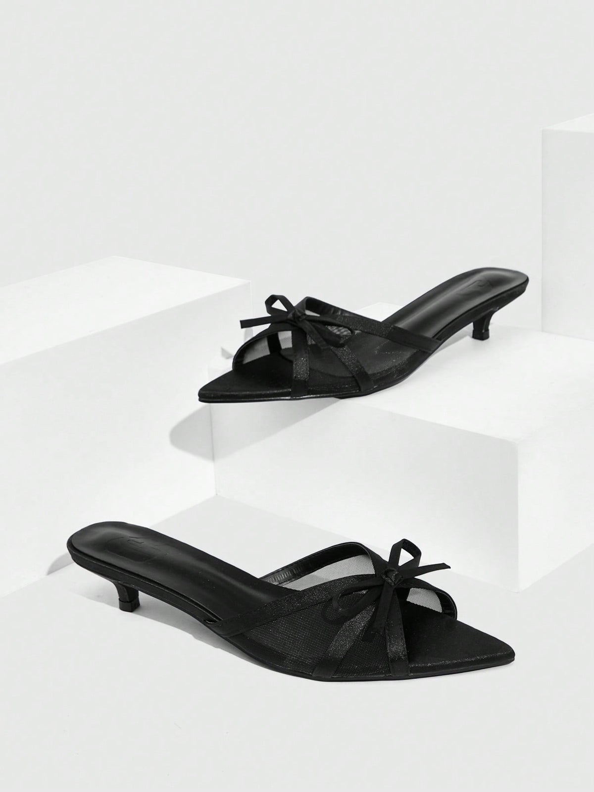 Pointed toe high-heeled slippers in PU leather with decorative buckle detail and low kitten heels for women.