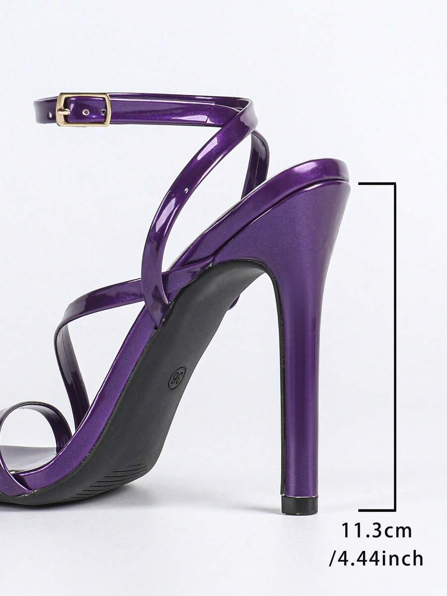 Glossy high heel sandals with open round toe, stiletto heel, and cross ankle buckle strap