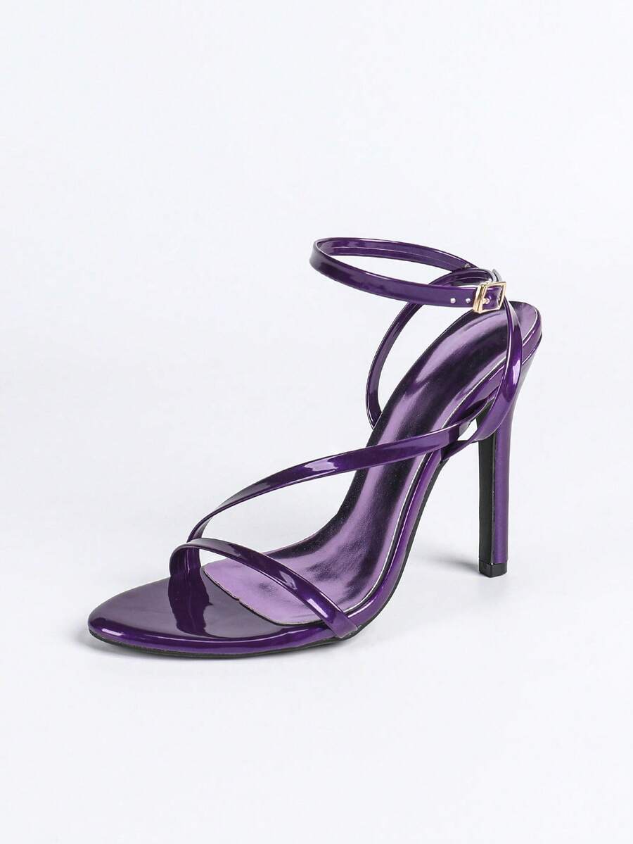 Glossy high heel sandals with open round toe, stiletto heel, and cross ankle buckle strap