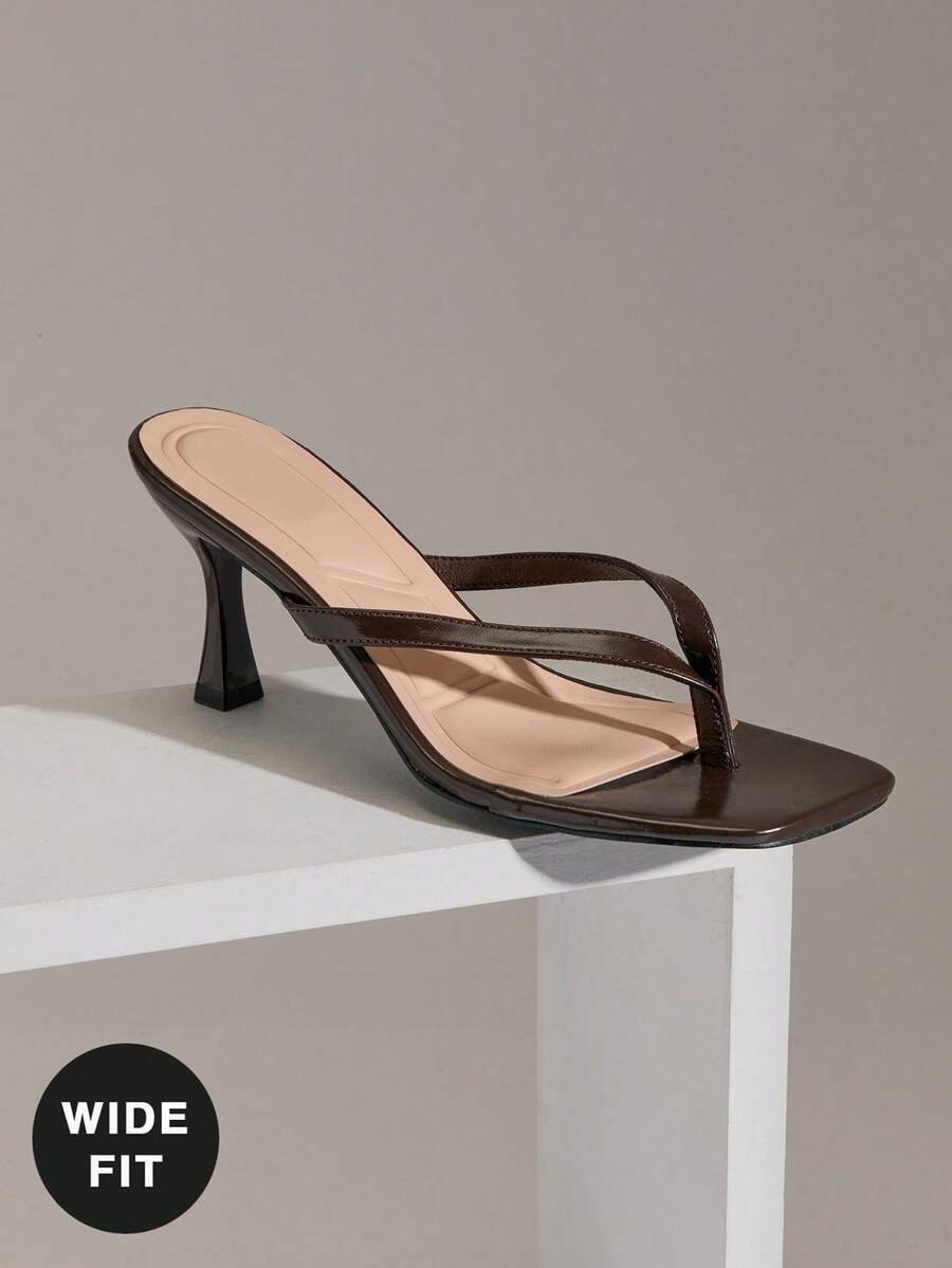 Women's square toe kitten heel thong heeled sandals featuring an asymmetrical strap design and mid heel