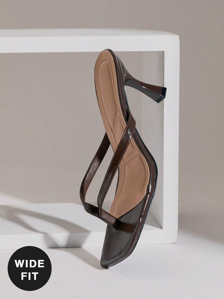 Women's square toe kitten heel thong heeled sandals featuring an asymmetrical strap design and mid heel