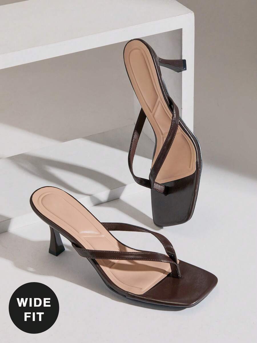 Women's square toe kitten heel thong heeled sandals featuring an asymmetrical strap design and mid heel