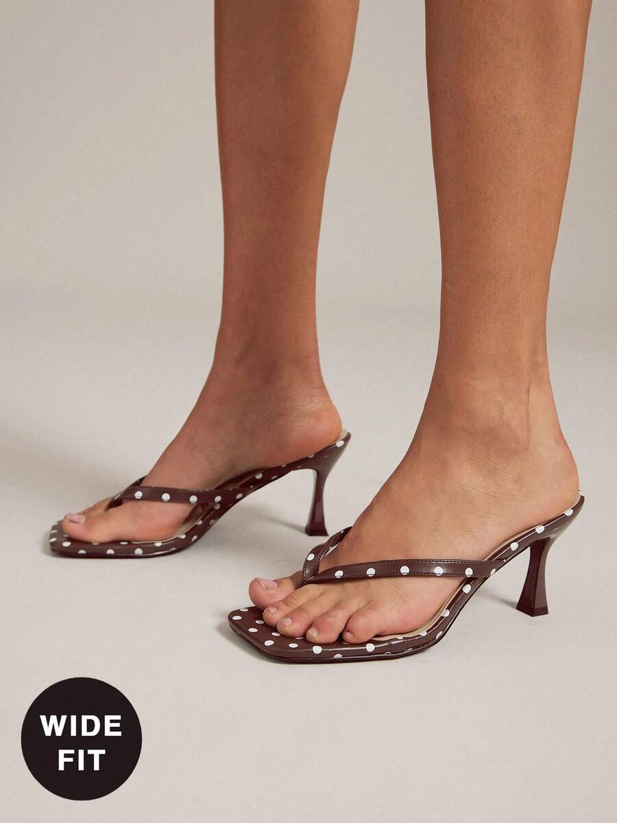 Women's square toe kitten heel thong heeled sandals featuring an asymmetrical strap design and mid heel