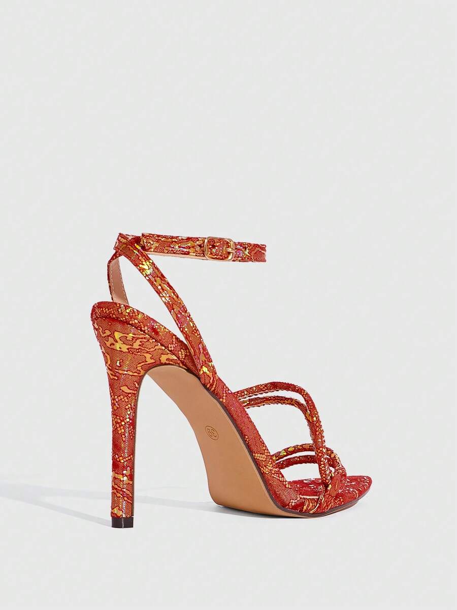 Snake pattern open toe high heel sandals with thin stiletto heel and buckle ankle strap for women.