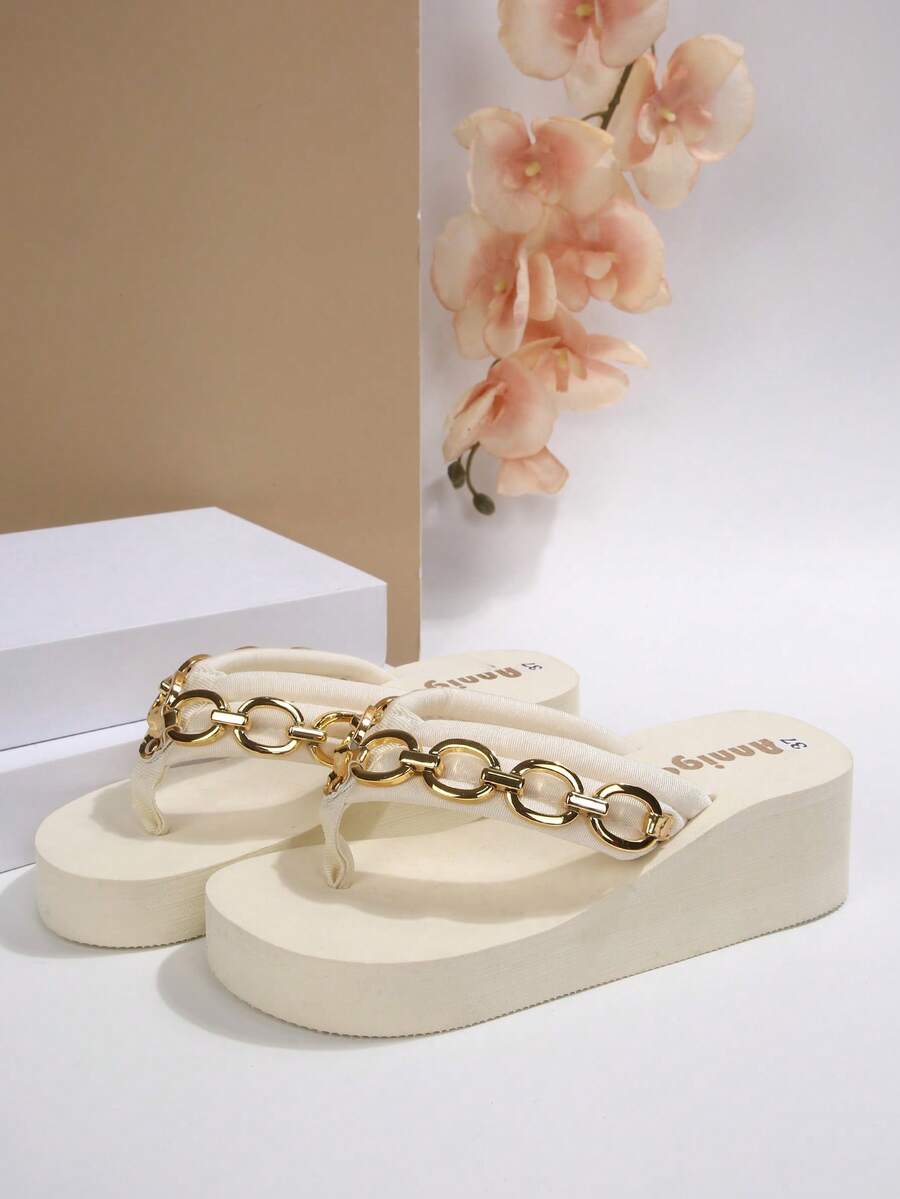 Beige platform wedge flip flop slippers featuring decorative chain and shell details with EVA sole for women.