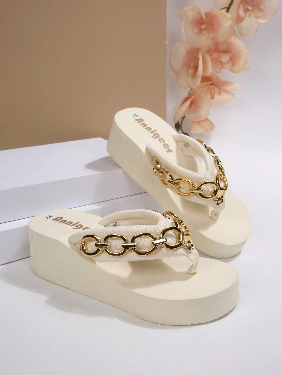Beige platform wedge flip flop slippers featuring decorative chain and shell details with EVA sole for women.