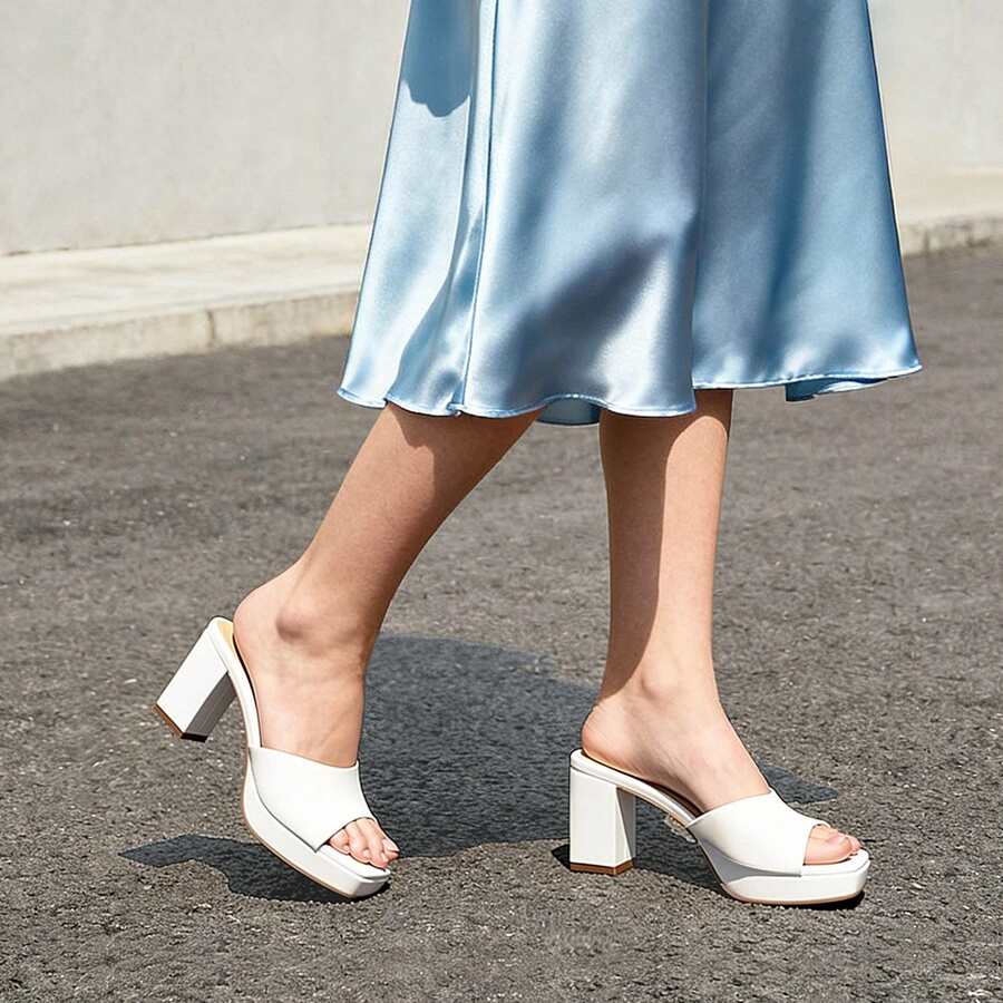 Women's minimalist open toe mule sandals featuring a chunky low heel, wide single strap, and slip-on design.