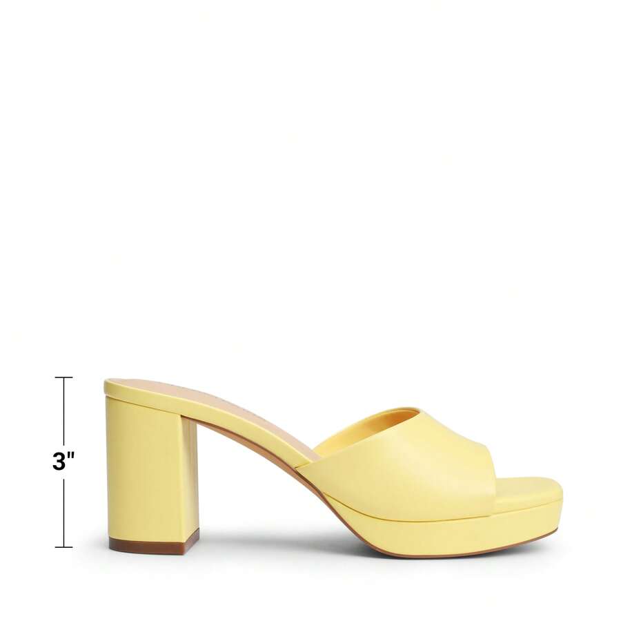 Women's minimalist open toe mule sandals featuring a chunky low heel, wide single strap, and slip-on design.