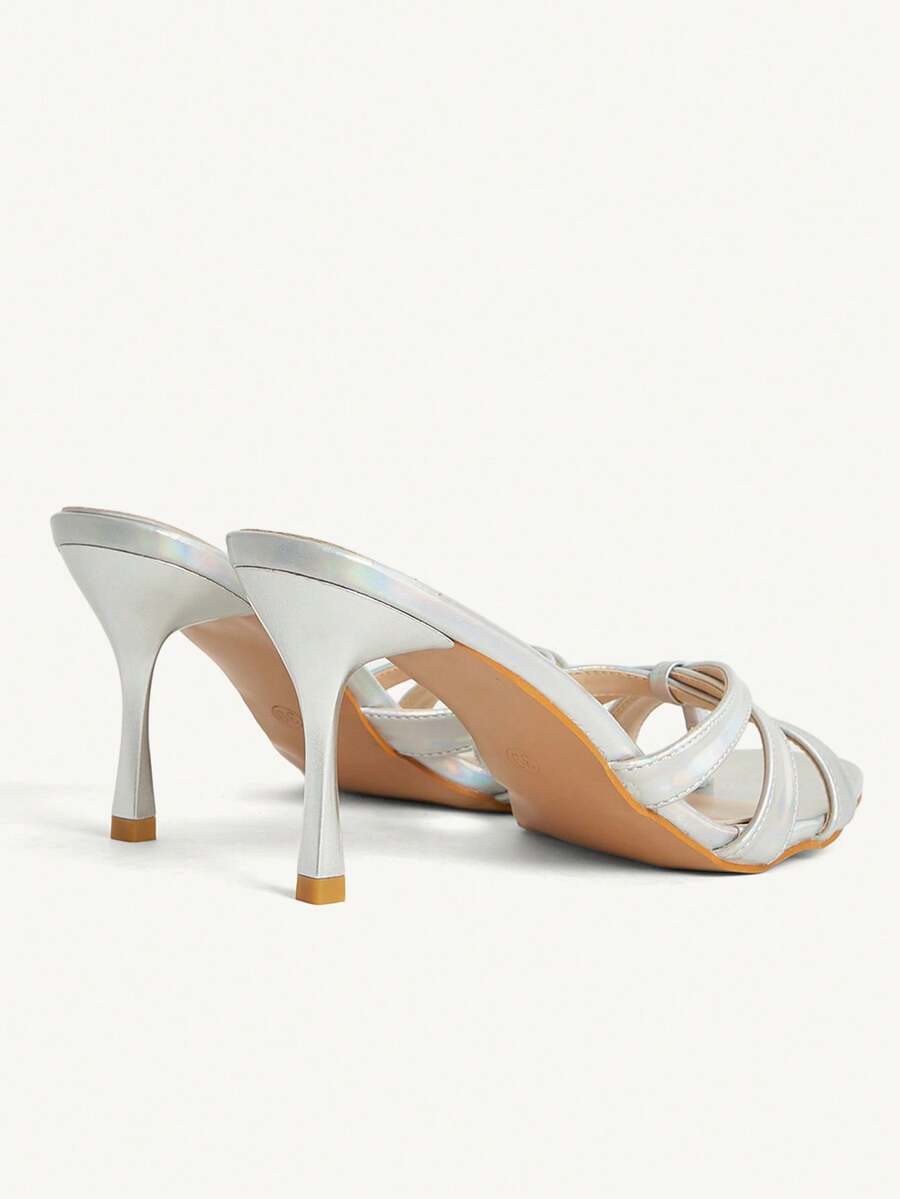 Square toe gold metallic heel sandals for women featuring open toe, crossover slingback strap, and stiletto mid heel for weddings and parties.