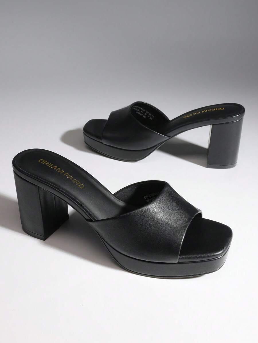 Women's minimalist open toe mule sandals featuring a chunky low heel, wide single strap, and slip-on design.