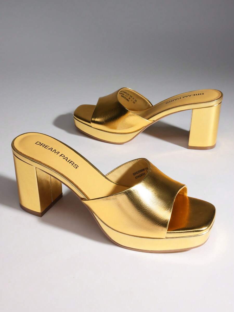 Women's minimalist open toe mule sandals featuring a chunky low heel, wide single strap, and slip-on design.