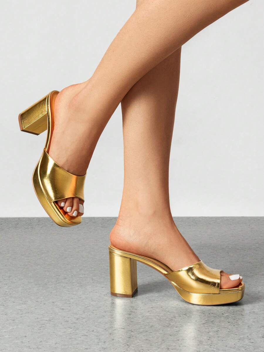 Women's minimalist open toe mule sandals featuring a chunky low heel, wide single strap, and slip-on design.