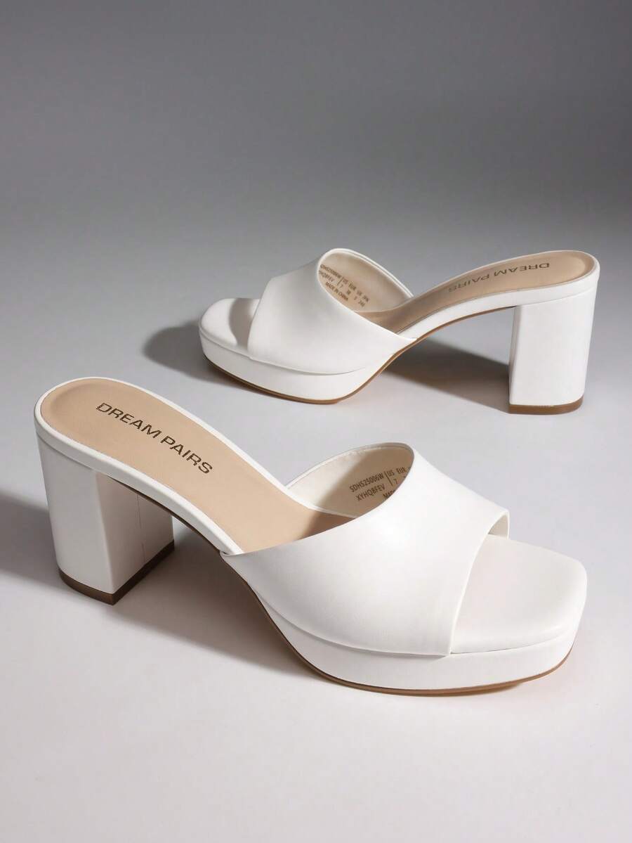 Women's minimalist open toe mule sandals featuring a chunky low heel, wide single strap, and slip-on design.