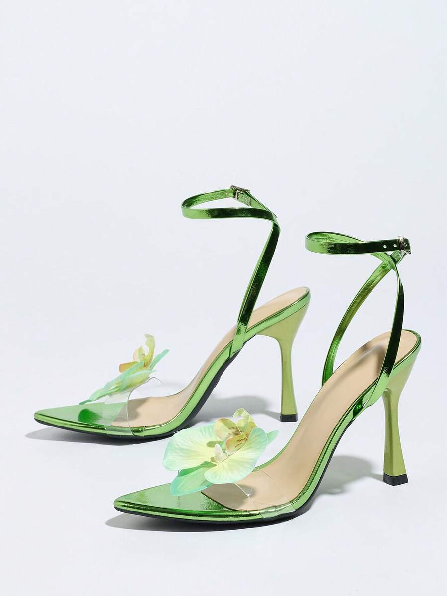 Women's black open toe stiletto heel sandals featuring lace mesh detailing, wide strap styling, and high stiletto heels.