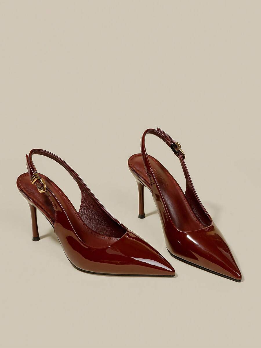 Women's pointed toe kitten heel pumps with adjustable buckle back strap and sleek patent finish.