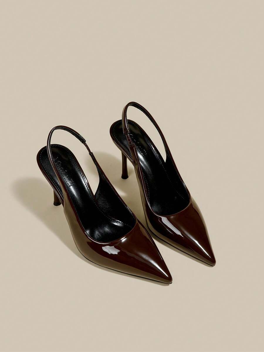 Women's pointed toe kitten heel pumps with adjustable buckle back strap and sleek patent finish.