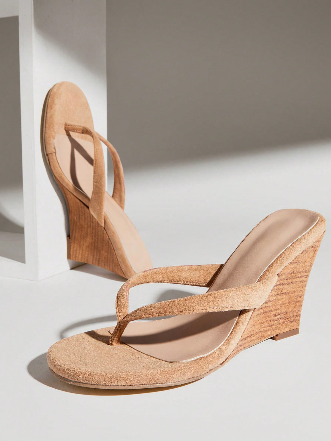 Women's faux suede thong wedge sandals featuring rope detail and high platform wedge sole