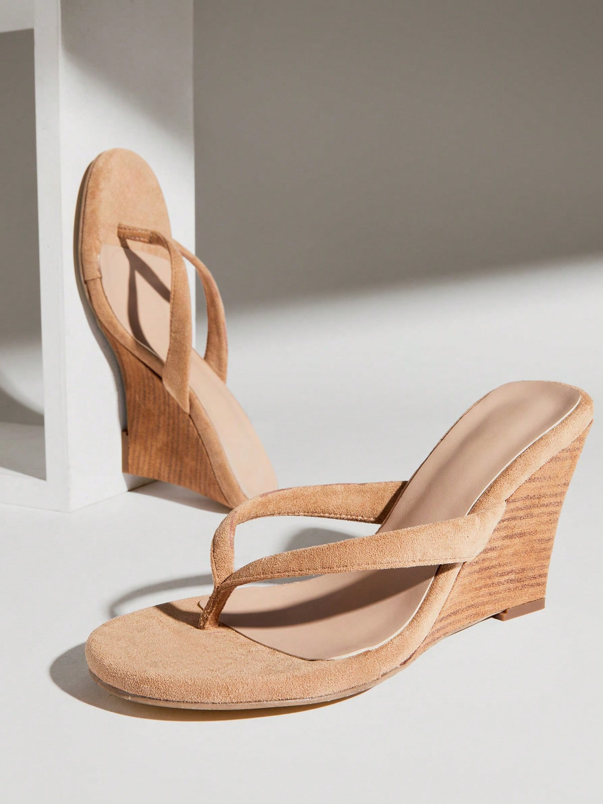 Women's faux suede thong wedge sandals featuring rope detail and high platform wedge sole