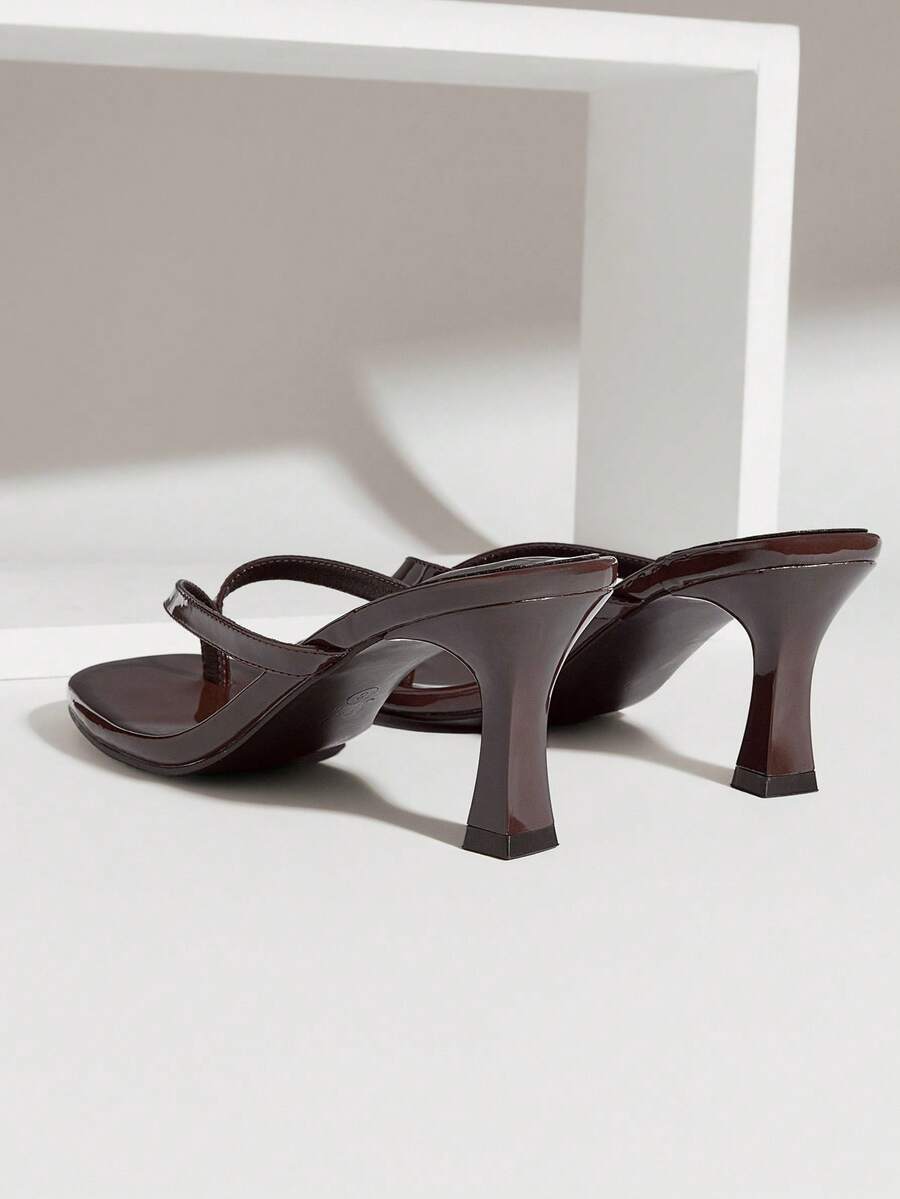 Women's minimalist black PU leather thong heel sandals featuring kitten heels and rhinestone accents