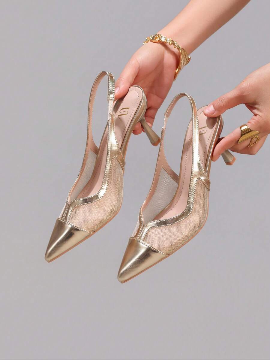 Pair of women's white pointed-toe kitten heel pumps with slingback straps and sleek patent finish