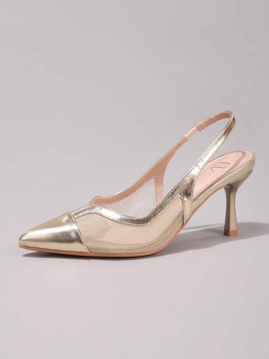 Pair of women's white pointed-toe kitten heel pumps with slingback straps and sleek patent finish
